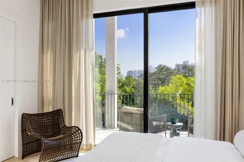a bedroom with furniture and a potted plant