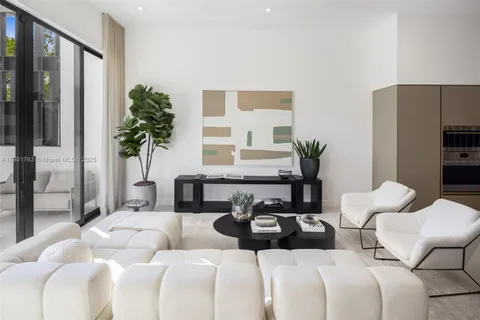 a bedroom with furniture and a large window