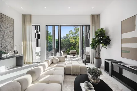 a living room with furniture and a floor to ceiling window