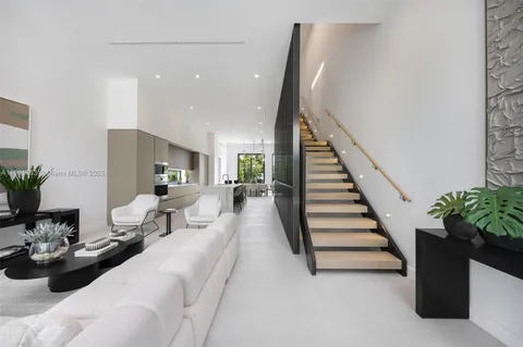 a living room with furniture and stairs