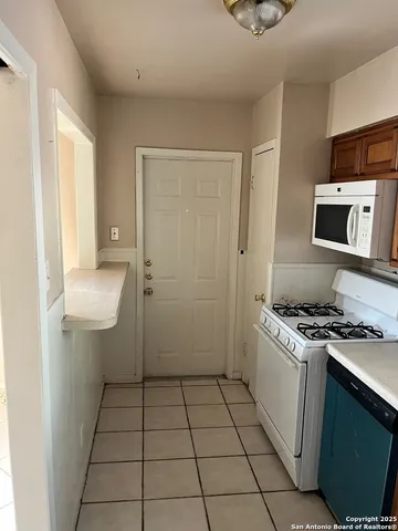 a kitchen with a sink a stove and cabinets