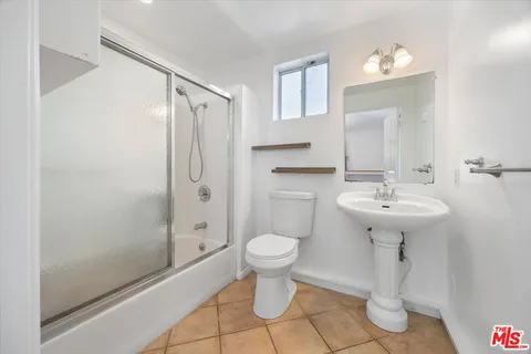 a bathroom with a sink toilet and a mirror