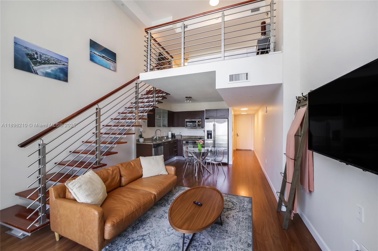 41 Southeast 5th Street, Unit 1003 Miami, FL 33131 - Photo 5 of 10 a living room with furniture a rug and white walls
