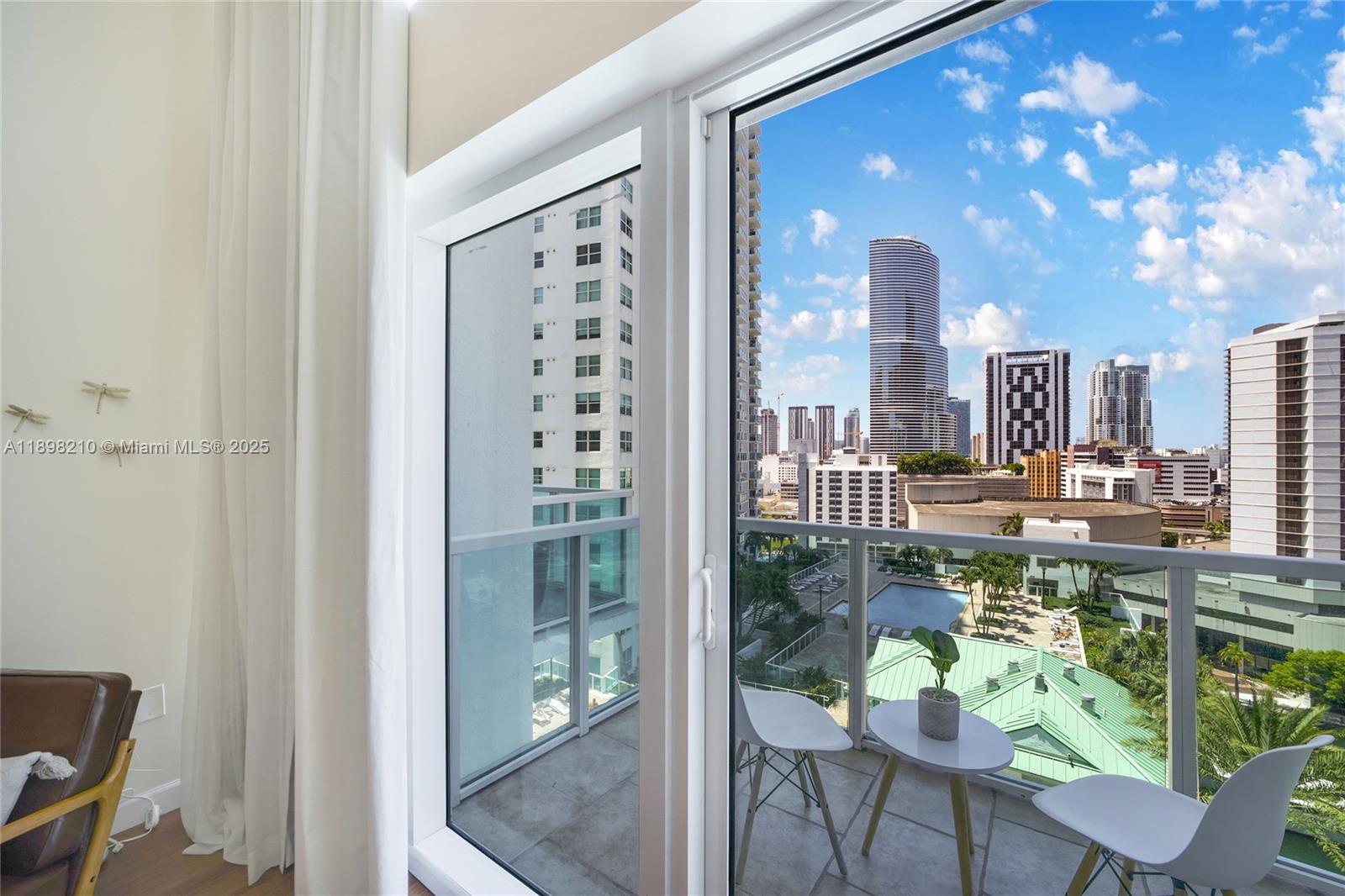 41 Southeast 5th Street, Unit 1003 Miami, FL 33131 - Photo 10 of 10 a city view with sitting space and glass windows
