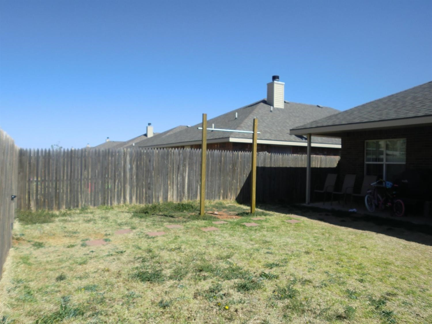 6706 84th Street Lubbock, TX 79424 - Photo 8 of 10 a front view of a house with a yard