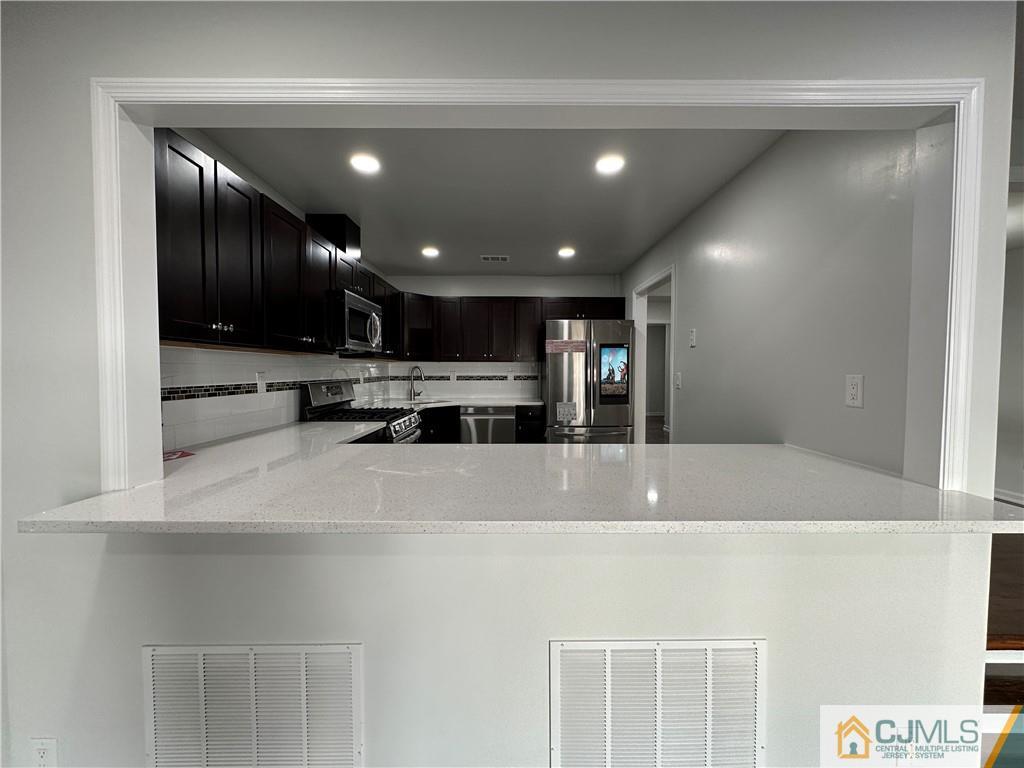 3703 Hana Road Edison, NJ 08817 - Photo 16 of 55 a view of kitchen with stainless steel appliances double vanity sink and stove