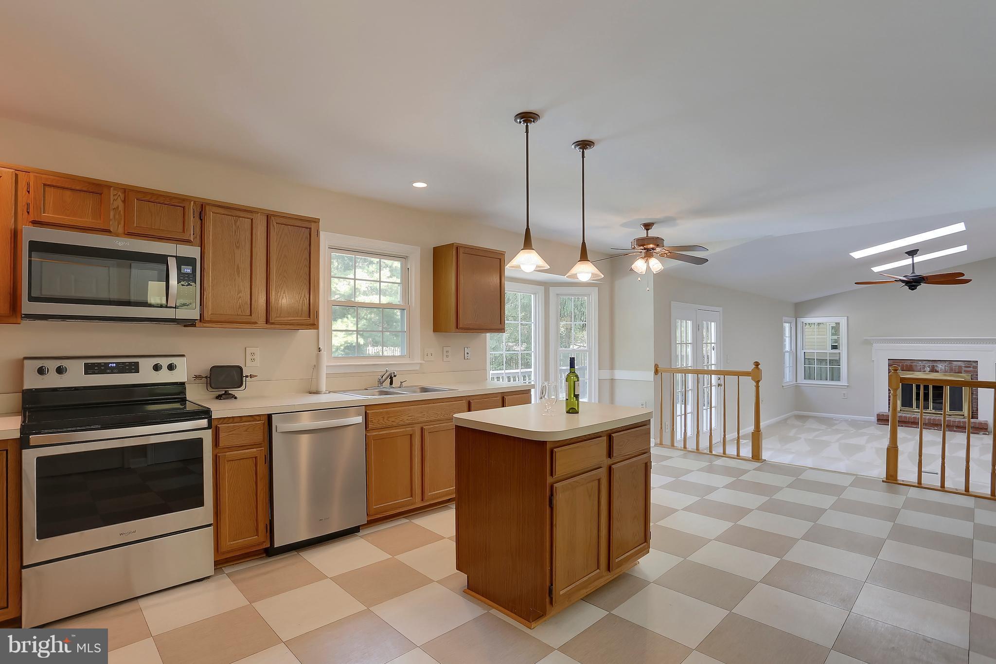 10812 Game Preserve Road Gaithersburg, MD 20879 - Photo 7 of 30 Pendant and recessed lighting accent the kitchen.