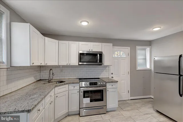 a kitchen with a sink stove and refrigerator