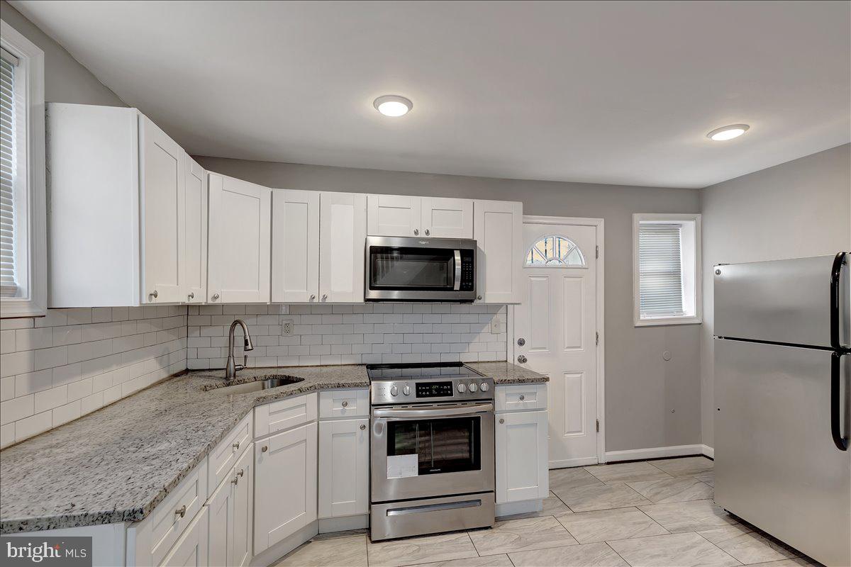 a kitchen with a sink stove and refrigerator
