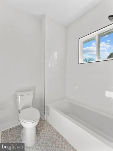 a bathroom with a toilet and a bathtub