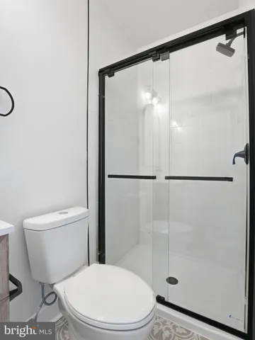 a white toilet sitting next to a bathroom sink