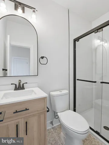 a bathroom with a toilet a sink and a mirror
