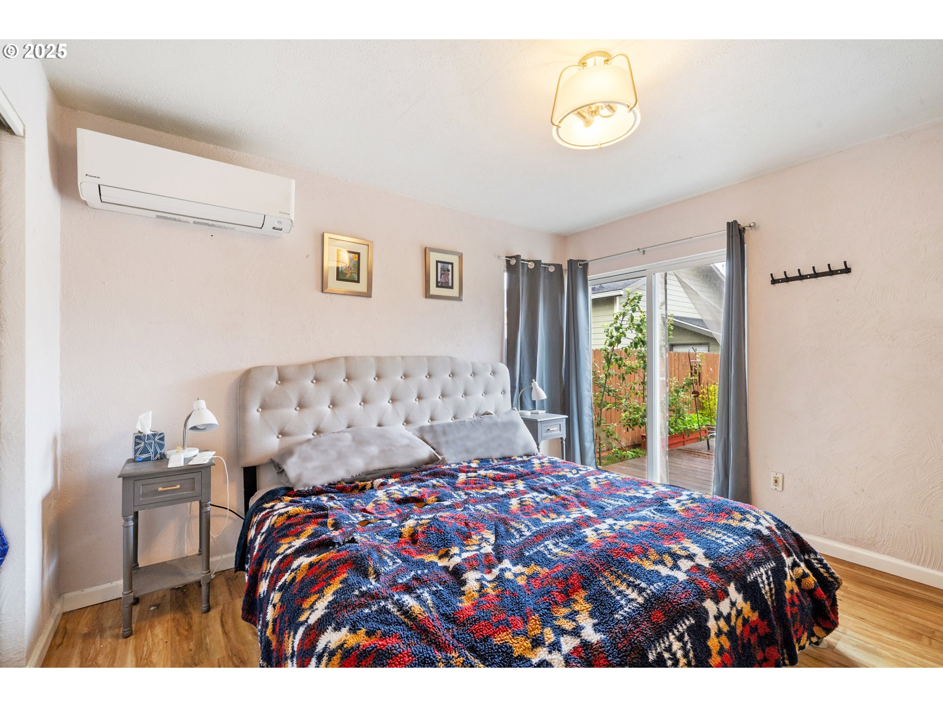 1706 5th Street Tillamook, OR 97141 - Photo 11 of 29 a bedroom with a bed and a window