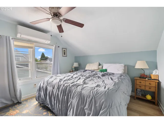 a bedroom with a bed a chandelier and a window