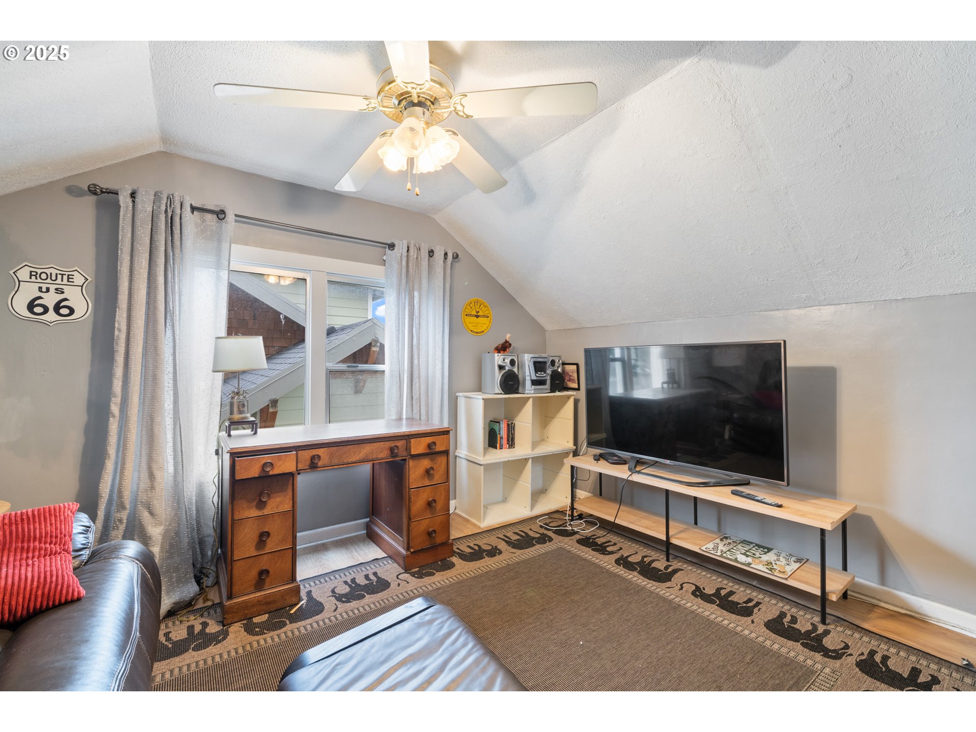 1706 5th Street Tillamook, OR 97141 - Photo 19 of 29 a living room with furniture and a flat screen tv