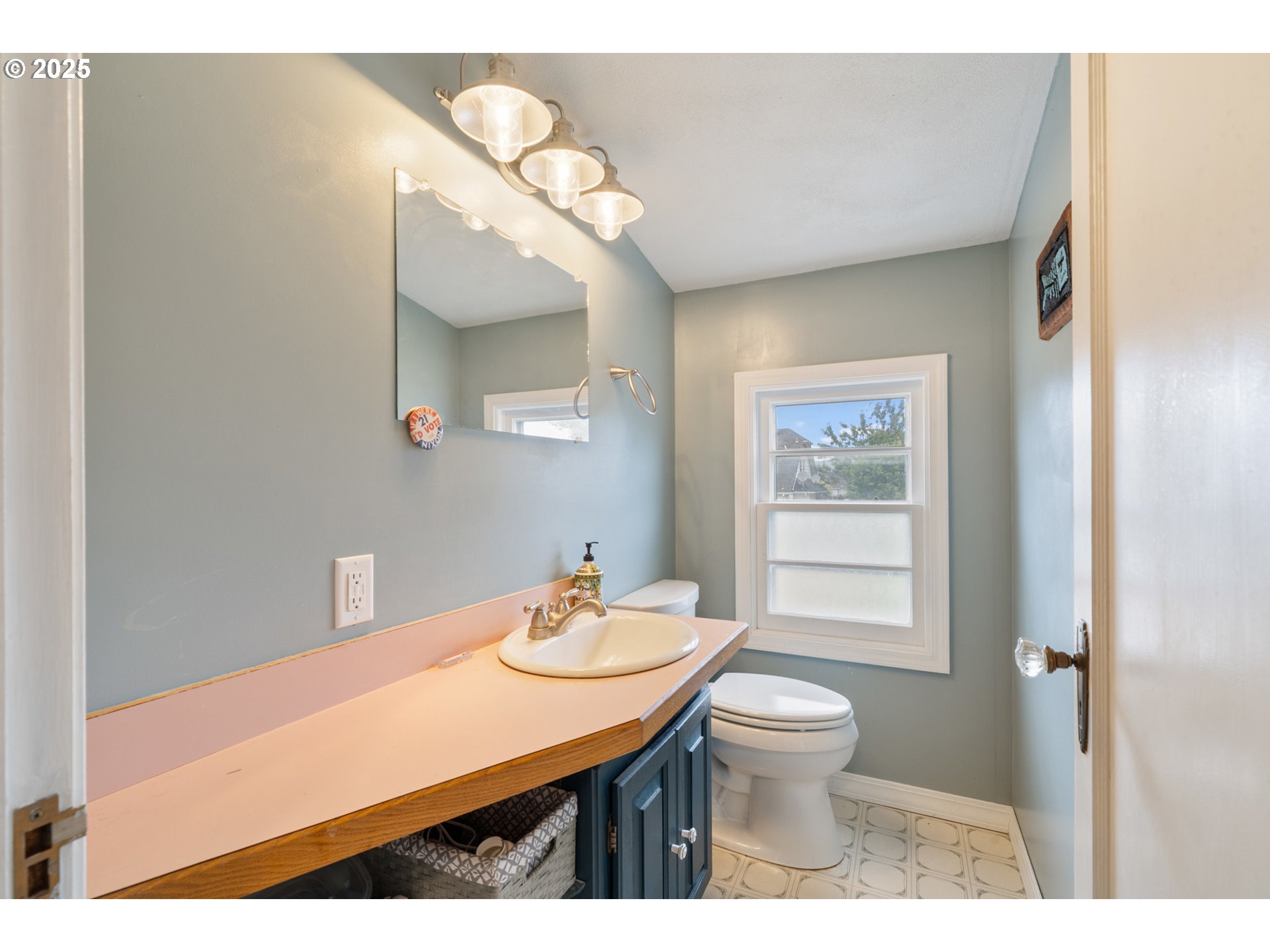1706 5th Street Tillamook, OR 97141 - Photo 20 of 29 a bathroom with a sink a toilet and mirror