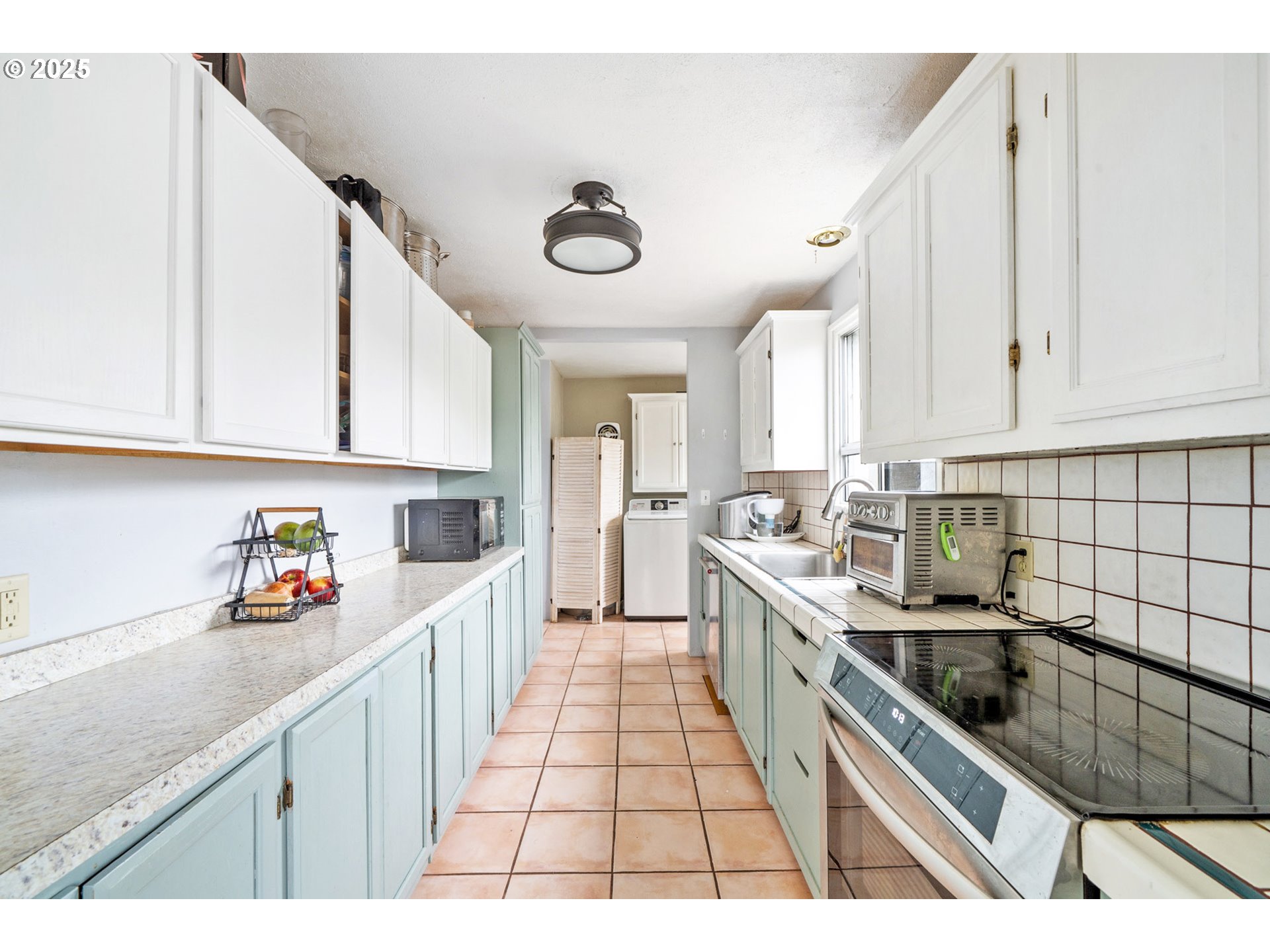 1706 5th Street Tillamook, OR 97141 - Photo 7 of 29 a open kitchen with stainless steel appliances granite countertop a sink and cabinets