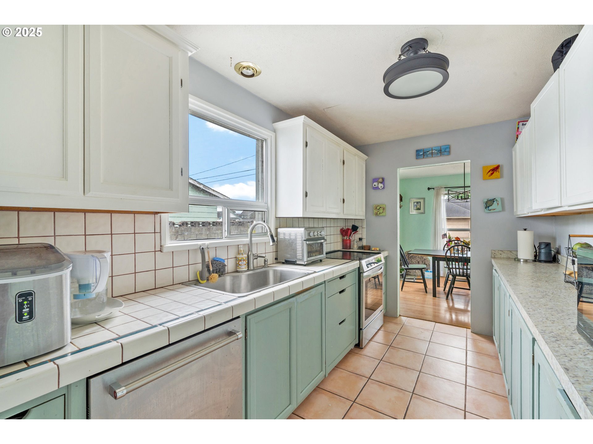 1706 5th Street Tillamook, OR 97141 - Photo 8 of 29 a kitchen with a sink cabinets and window