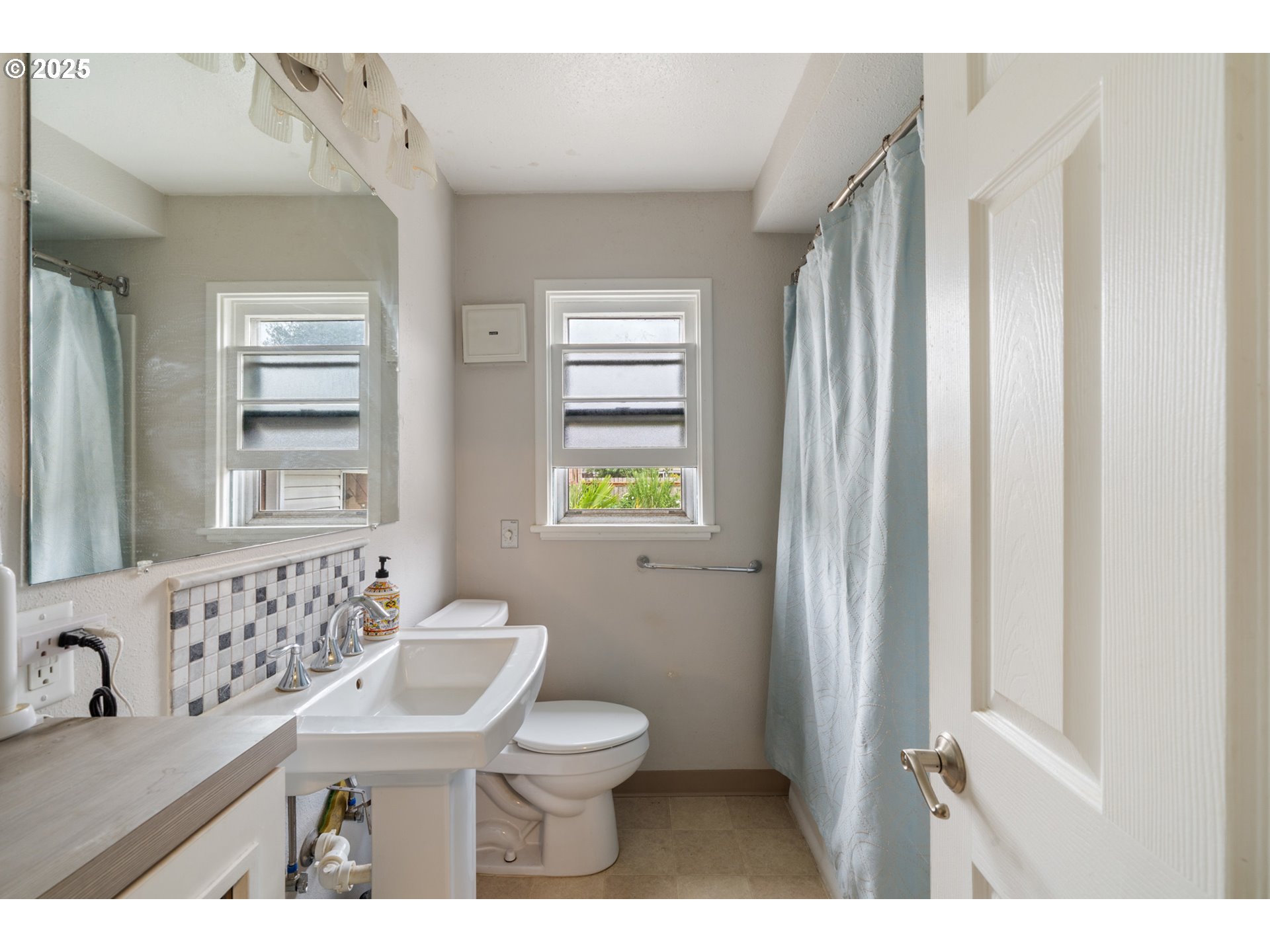 1706 5th Street Tillamook, OR 97141 - Photo 9 of 29 a bathroom with a sink a toilet and a window