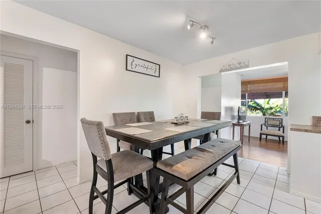 a view of a dining room and livingroom furniture wooden floor and a rug