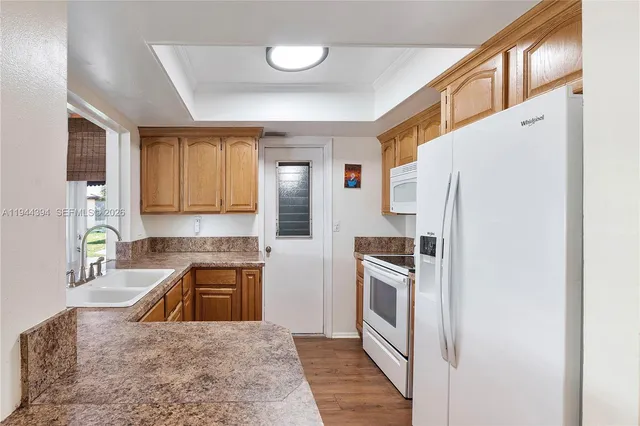 a kitchen with a refrigerator stove and sink