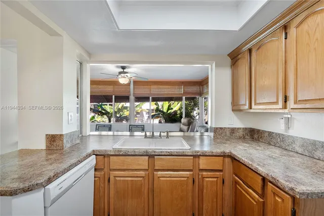 a kitchen with stainless steel appliances granite countertop a sink and a granite counter tops