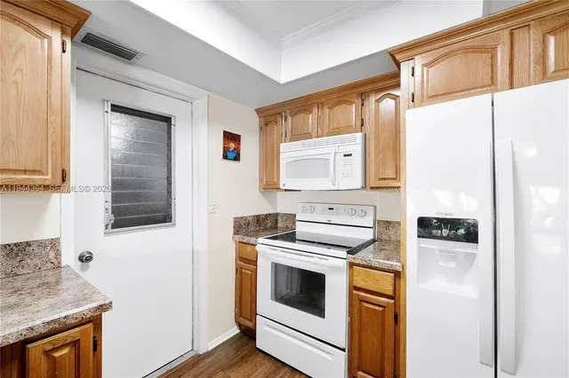 a kitchen with a stove a sink and a refrigerator