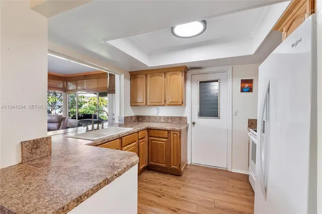 a kitchen with stainless steel appliances granite countertop sink stove and refrigerator