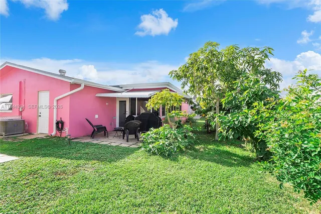 a backyard of a house with lots of green space and fountain