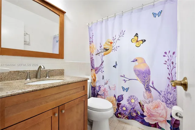 a bathroom with a sink mirror vanity and toilet