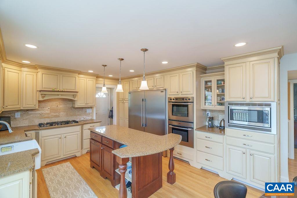 2976 Cove Trace Charlottesville, VA 22911 - Photo 18 of 62 a large kitchen with stainless steel appliances kitchen island granite countertop a sink and cabinets