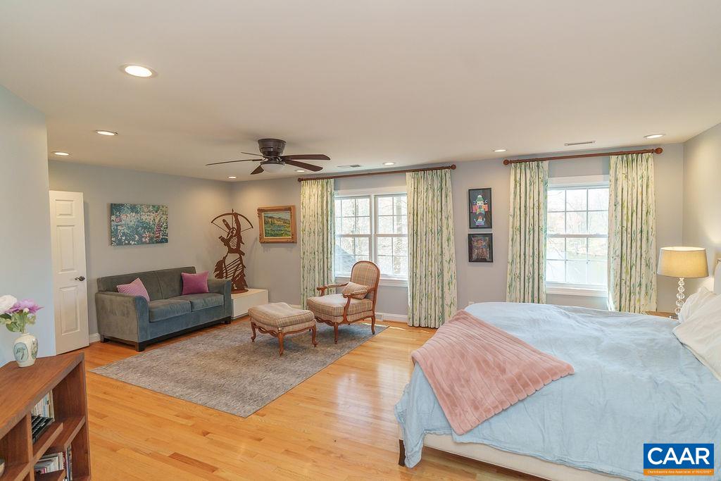 2976 Cove Trace Charlottesville, VA 22911 - Photo 30 of 62 a spacious bedroom with a bed a couch and a window