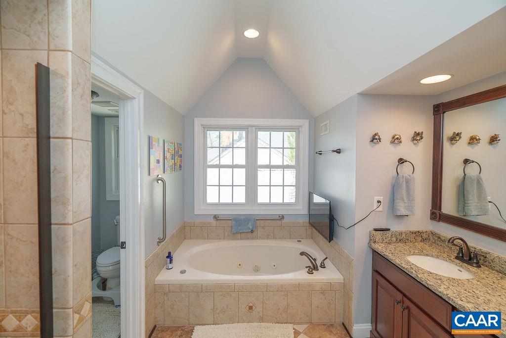 2976 Cove Trace Charlottesville, VA 22911 - Photo 31 of 62 a bathroom with a tub sink and mirror