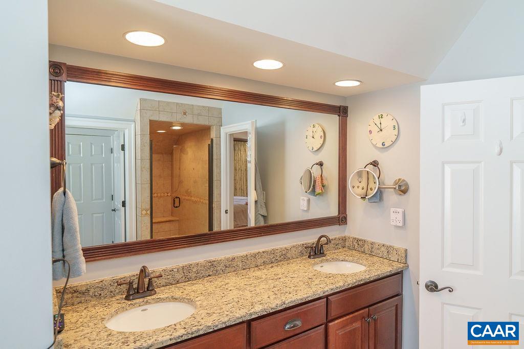 2976 Cove Trace Charlottesville, VA 22911 - Photo 33 of 62 a bathroom with a granite countertop sink and a mirror