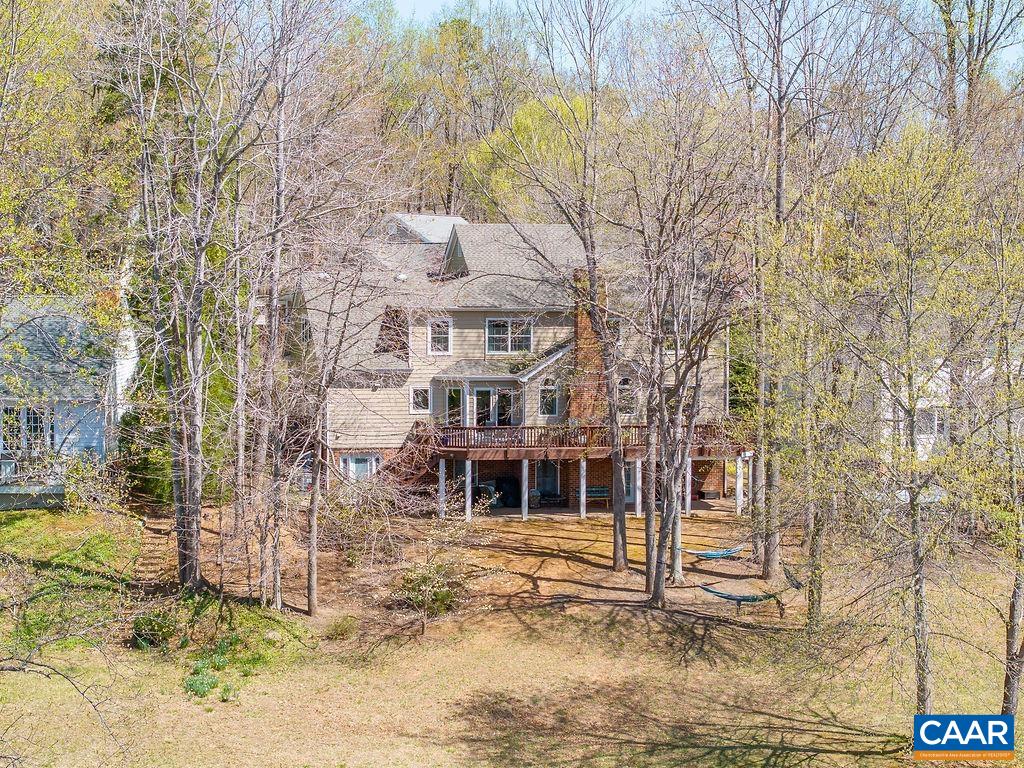 2976 Cove Trace Charlottesville, VA 22911 - Photo 53 of 62 a view of a white house next to a yard with large trees