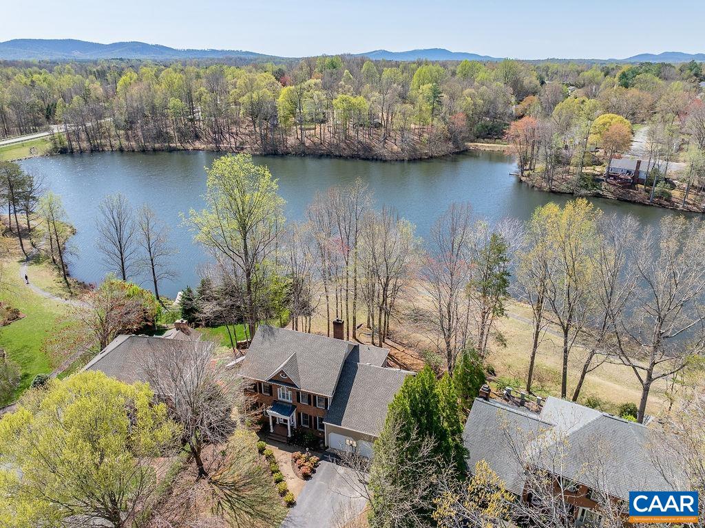 2976 Cove Trace Charlottesville, VA 22911 - Photo 58 of 62 a view of a lake with a mountain in the background
