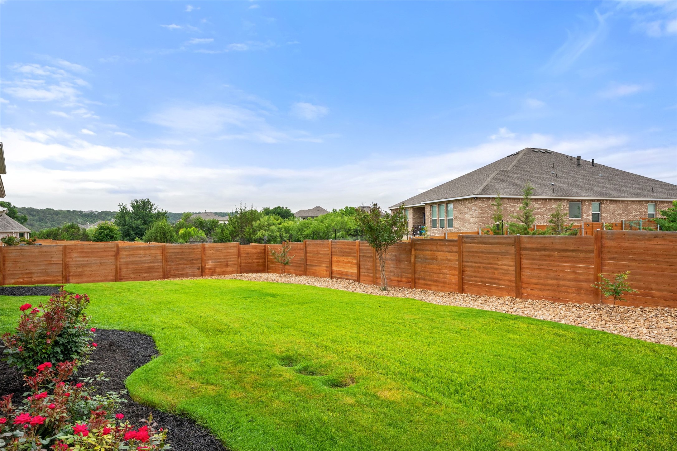 1513 Hinterwald Street Leander, TX 78641 - Photo 27 of 40 a view of a backyard with a garden