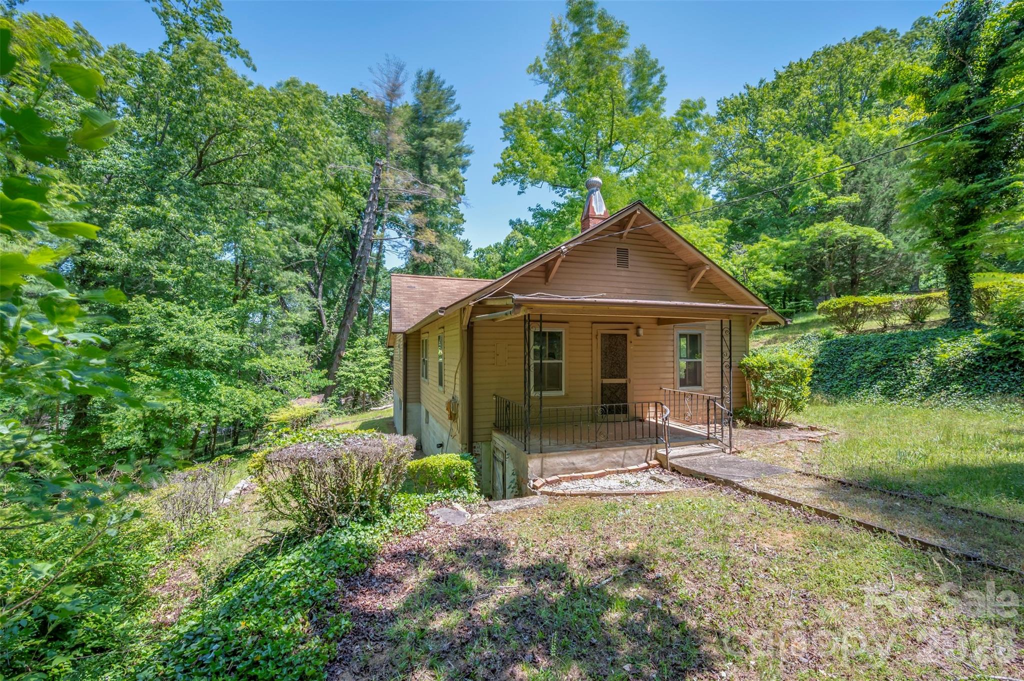 77 1st Street Tryon, NC 28782 - Photo 6 of 20 a front view of a house with a yard and pathway