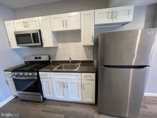 a kitchen with a refrigerator stove and microwave