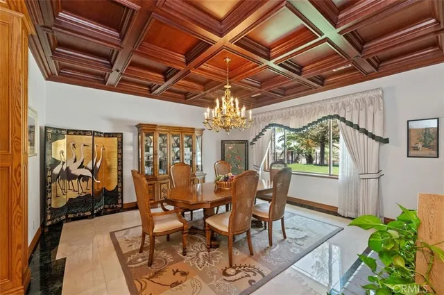 a view of a dining room with furniture a chandelier and wooden floor