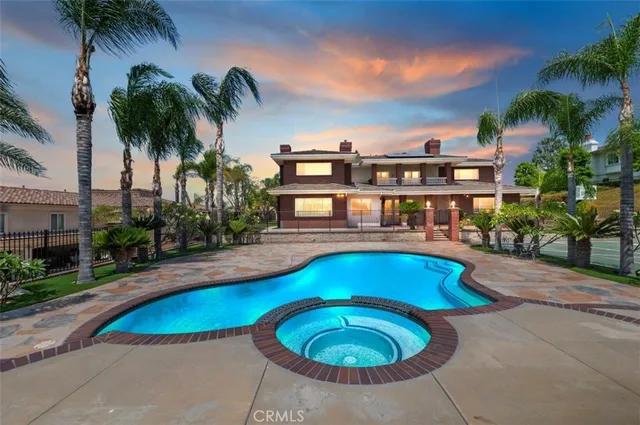 a view of a tennis ground with large trees