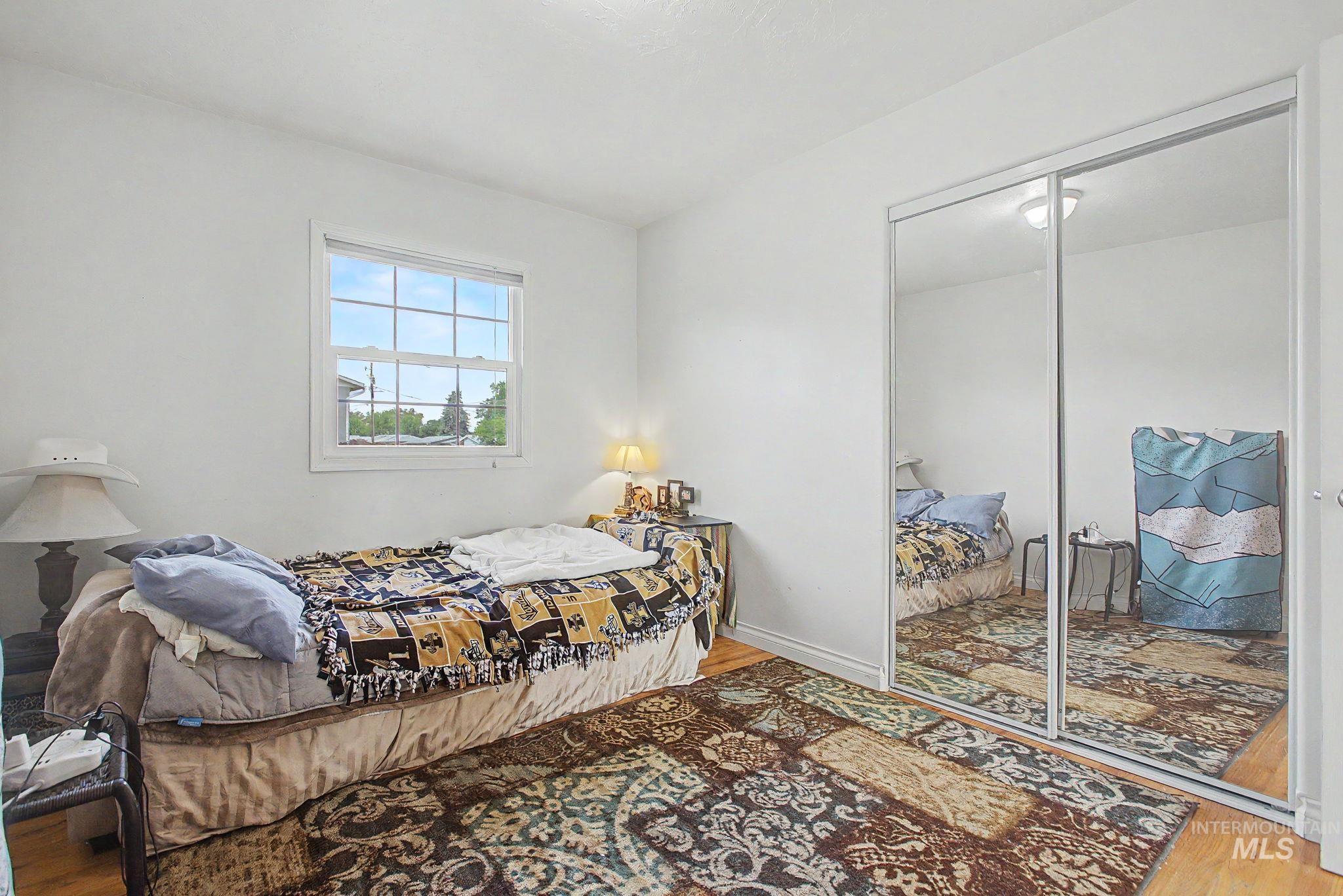 3314 6th Street Lewiston, ID 83501 - Photo 25 of 50 Room featuring a window with white trim, light-colored walls, and a built-in mirrored closet