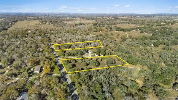 an aerial view of house with yard and mountain view in back