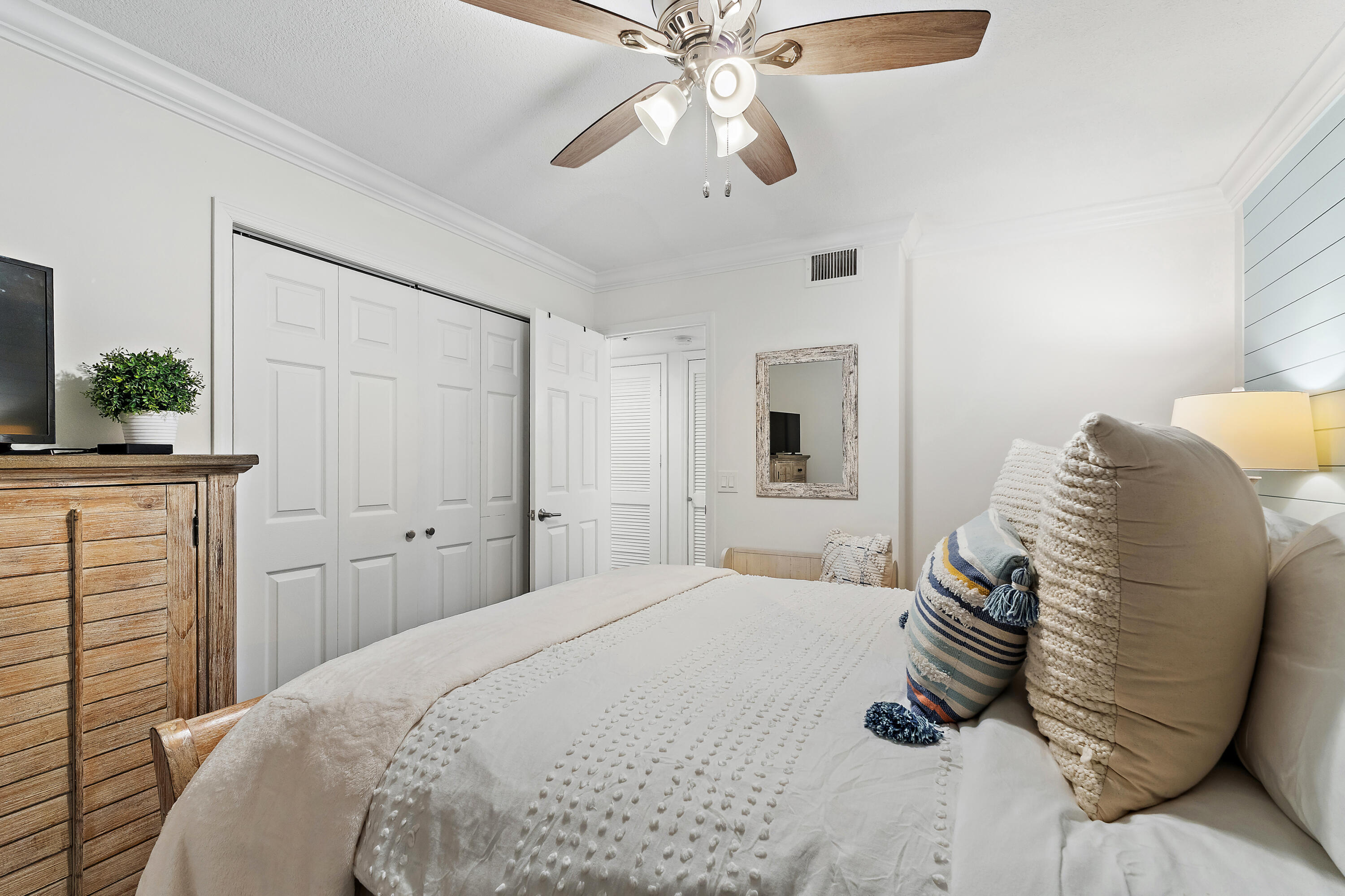 275 Palm Avenue, Unit A301 Jupiter, FL 33477 - Photo 12 of 38 a bedroom with a bed and a chandelier