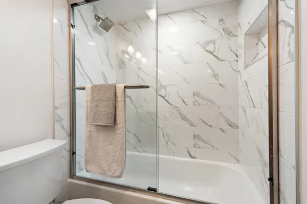 a bathroom with a bathtub and a shower