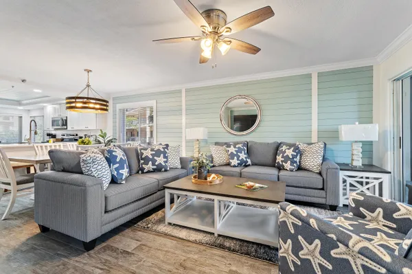 a living room with furniture a fireplace and a chandelier