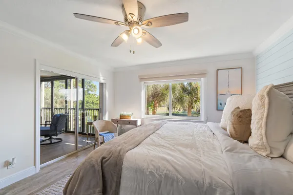 a spacious bedroom with a bed and a large window