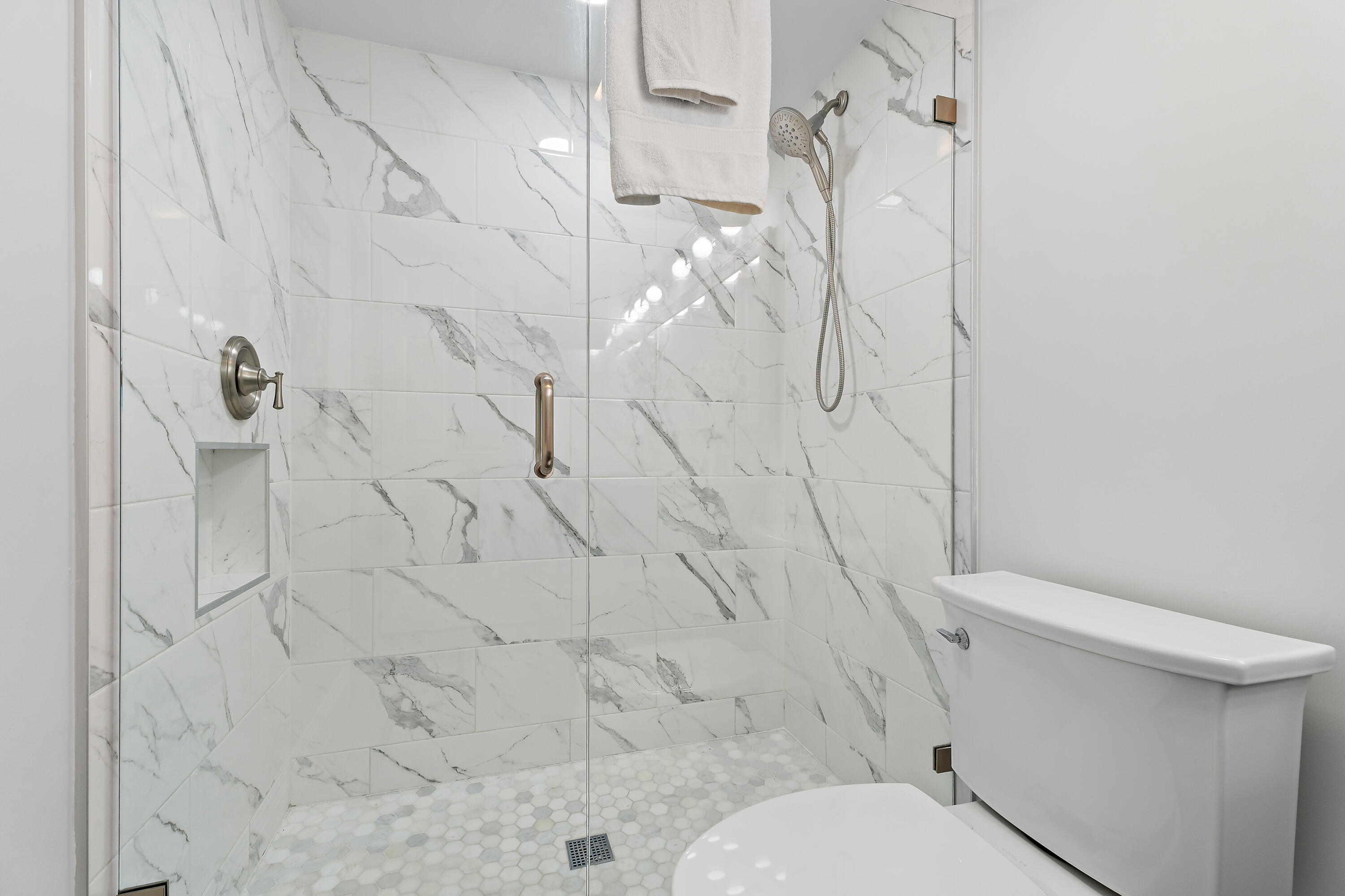 275 Palm Avenue, Unit A301 Jupiter, FL 33477 - Photo 29 of 38 a white toilet sitting next to a shower