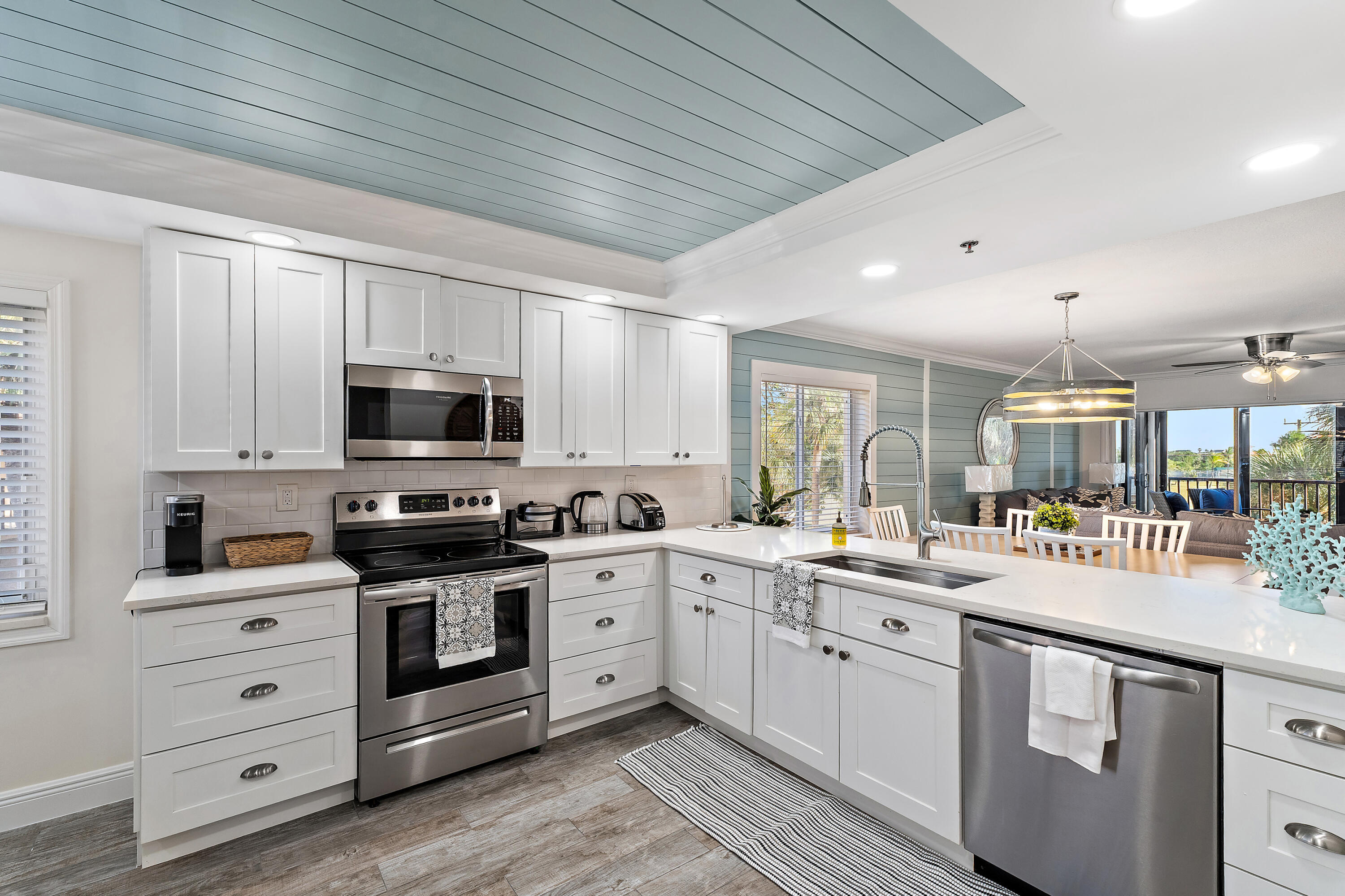 275 Palm Avenue, Unit A301 Jupiter, FL 33477 - Photo 3 of 38 a kitchen with stainless steel appliances white cabinets sink and stove top oven