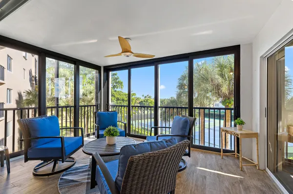 a living room with furniture and floor to ceiling windows
